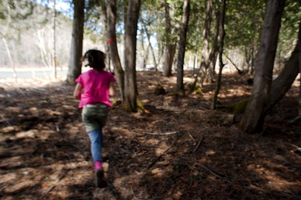 girl running through woods